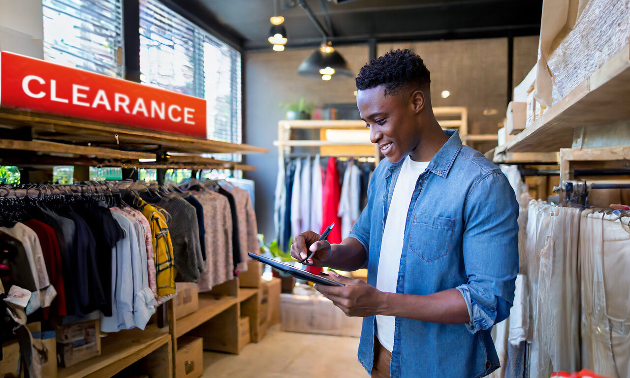 Man does inventory in his clothing store